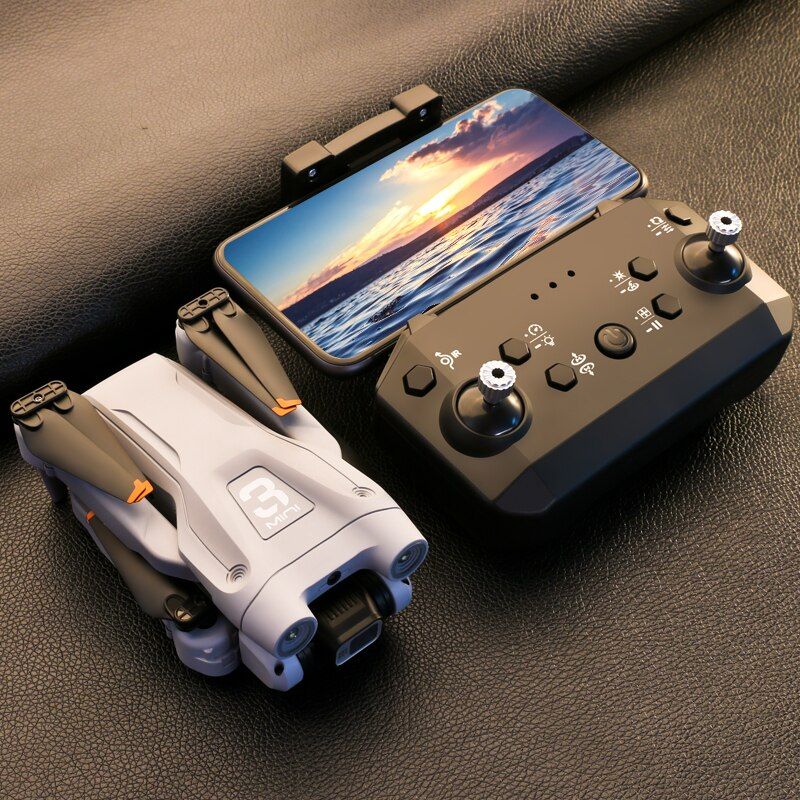 Handheld gaming console with controller and phone on a dark surface