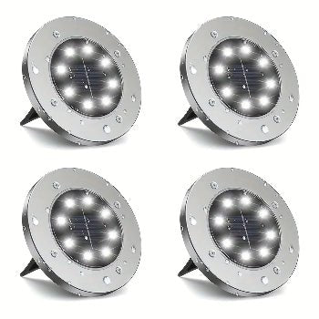 Four solar-powered ground lights on a white background