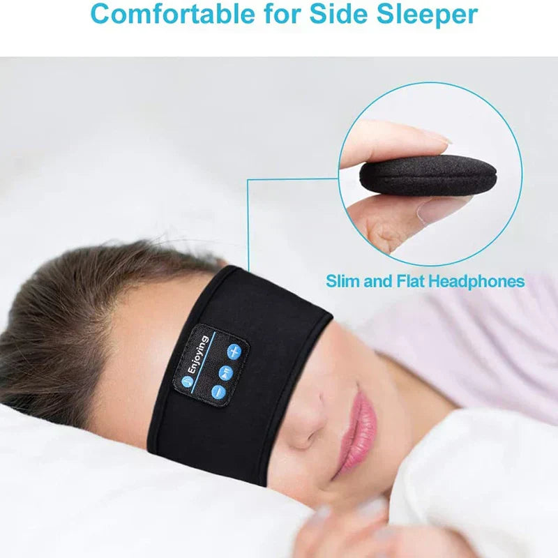 Person wearing black Bluetooth headphones for side sleepers with close-up of earbud.
