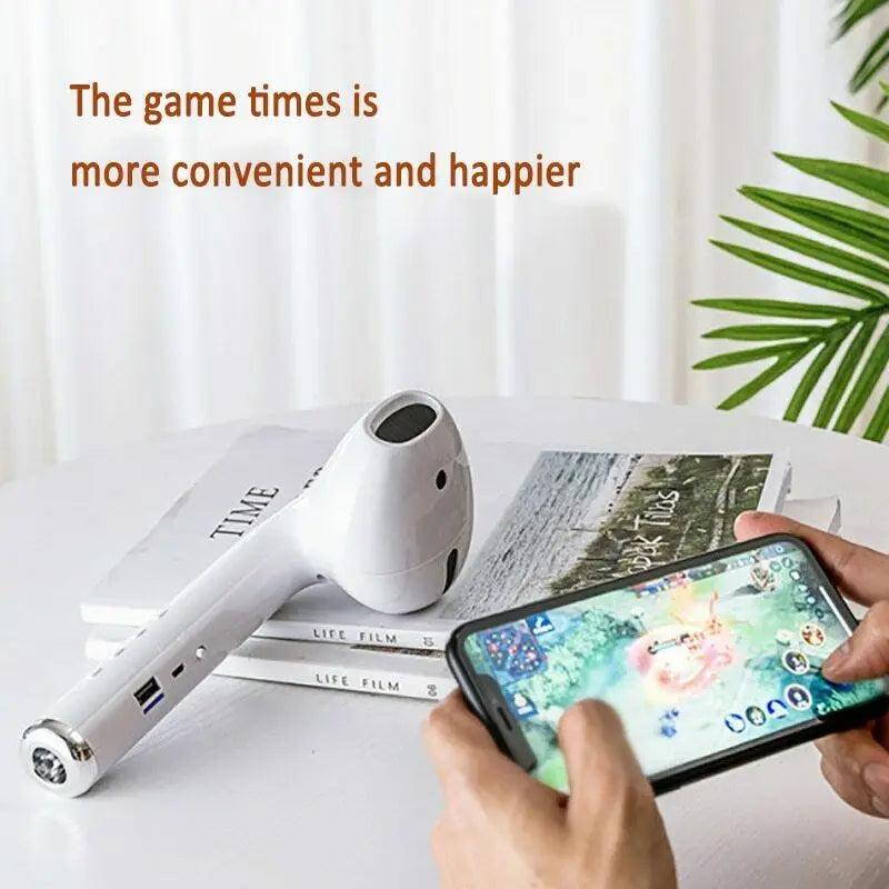 White electronic device on a stack of books with a smartphone displaying a game, text overlay 'The game times is more convenient and happier'.