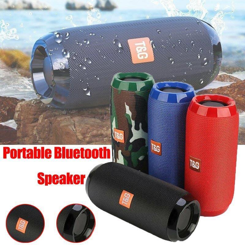Portable Bluetooth speaker with T&G branding in various colors against a natural background.