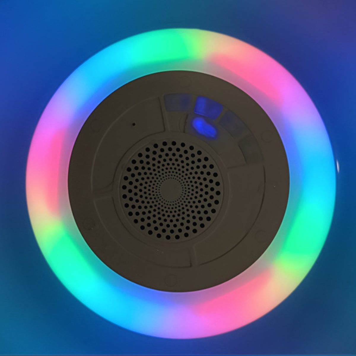 Colorful LED light ring with a central speaker on a dark background