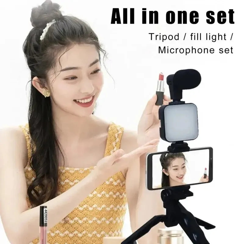 Woman holding a smartphone with a microphone and light attachment, displaying 'All in one set' text.