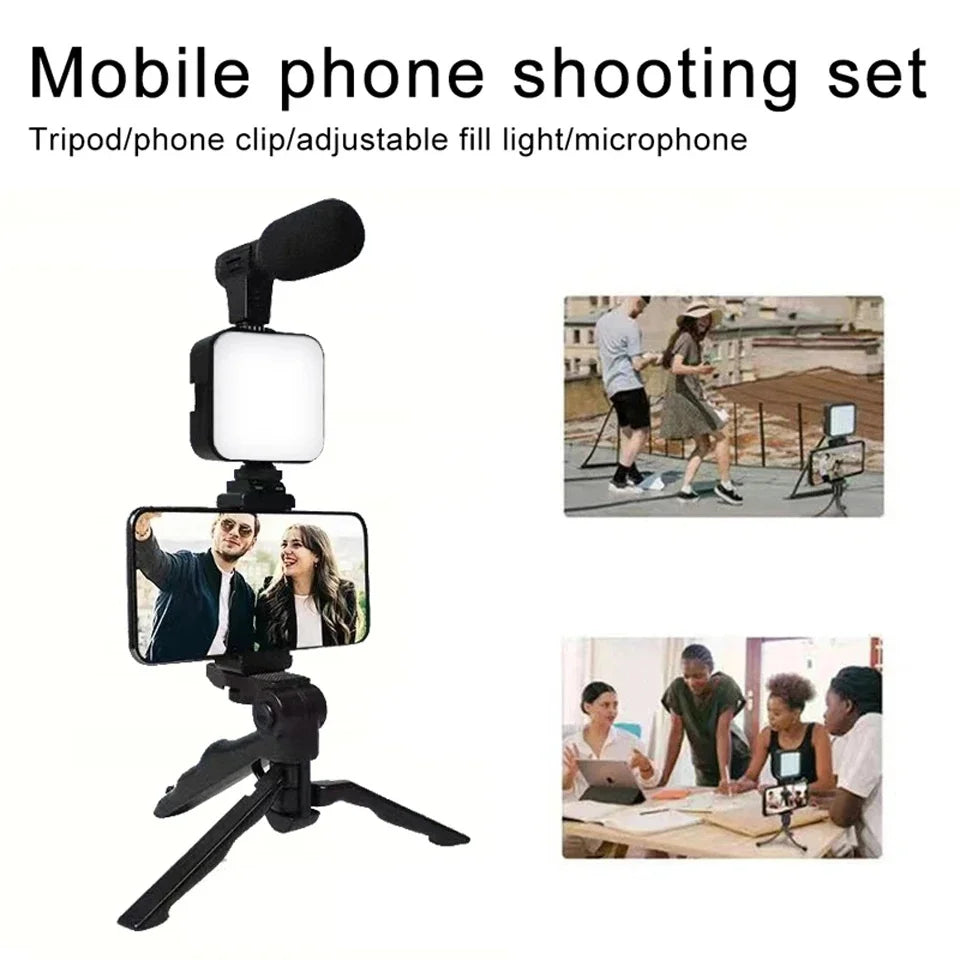 Mobile phone shooting set with tripod, phone clip, adjustable fill light, and microphone on a white background.