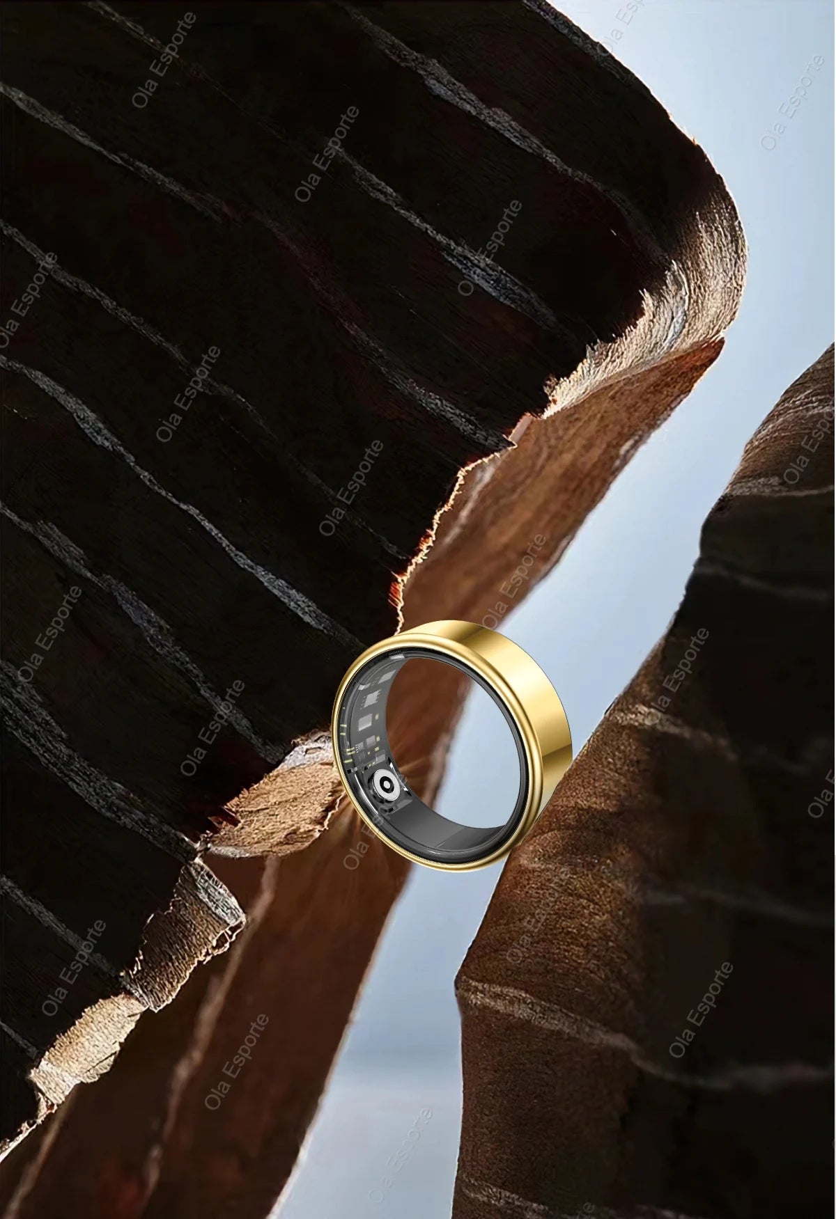 Gold ring with a black stone on a textured surface