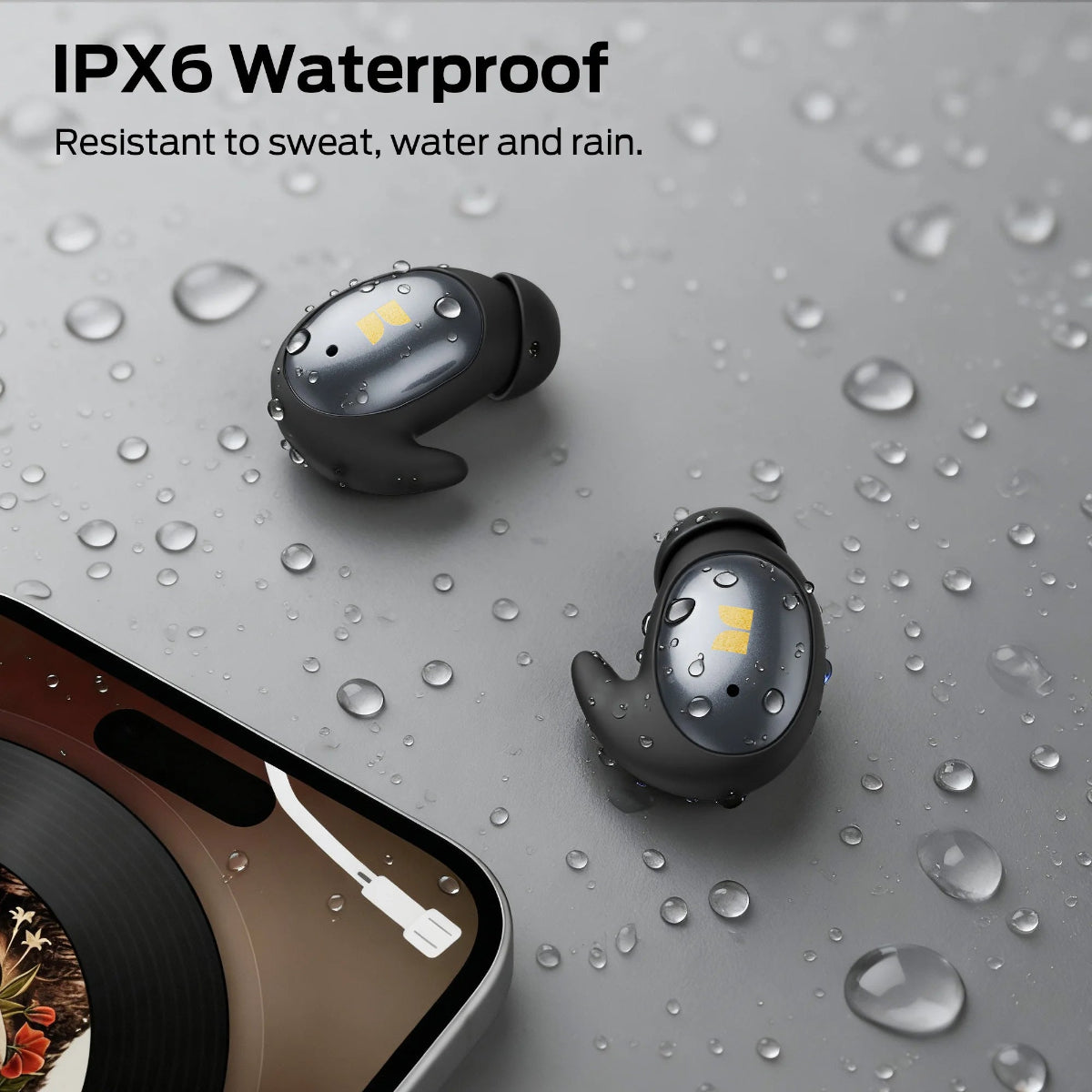 True wireless earbuds with water resistance feature on a wet surface