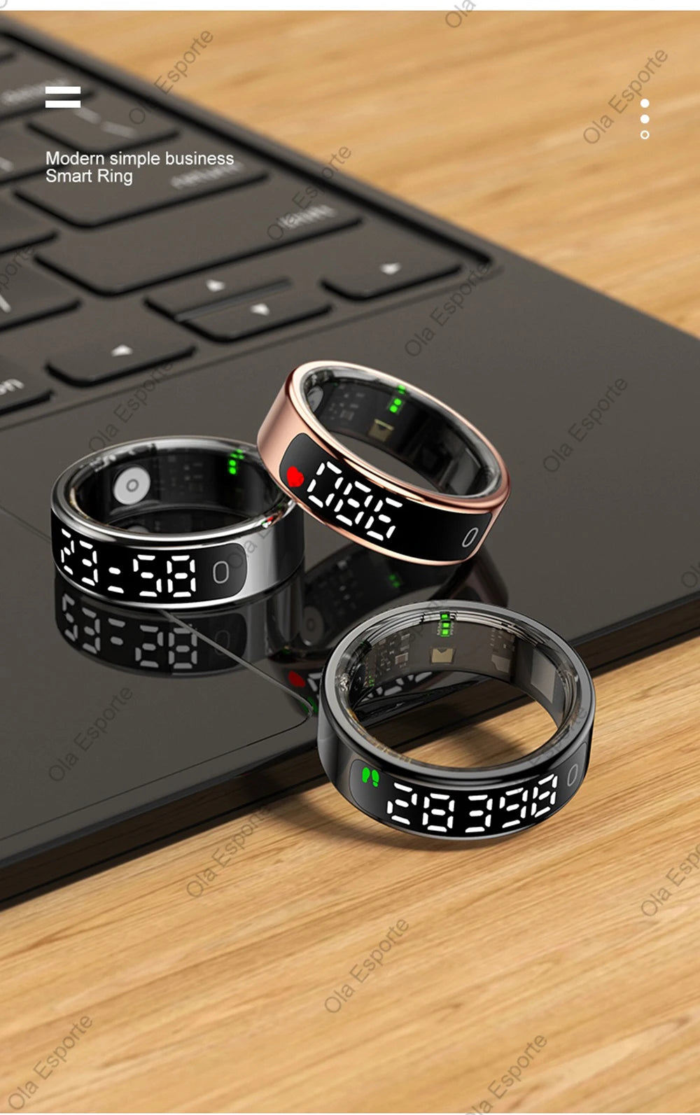 Three smart rings with digital displays on a wooden surface next to a laptop.