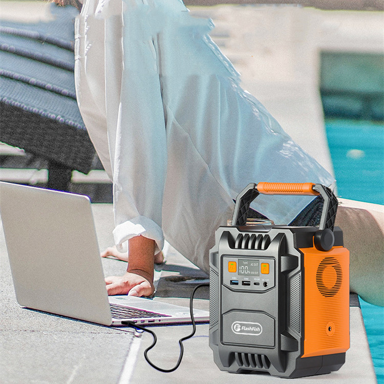Person using a portable power station to charge a laptop by a poolside.