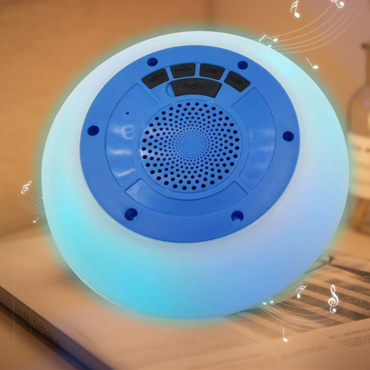 Round blue device with a central speaker grille on a beige background