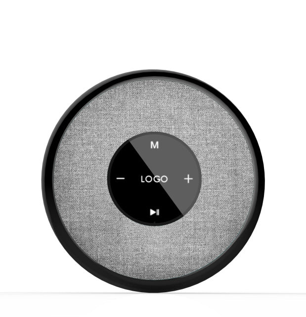 Round gray speaker with control buttons on a white background