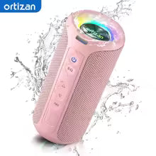 Pink Bluetooth speaker with water splashes and Ortizan branding on a white background