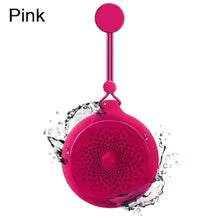 Pink portable speaker with water splashes on a white background