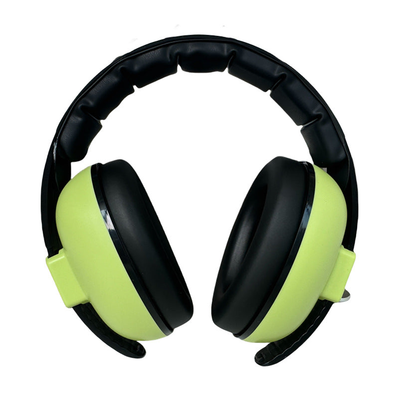 Black and green ear protectors on a white background