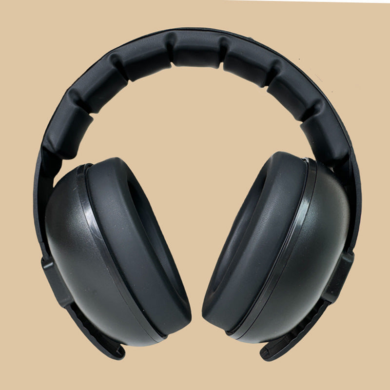 Black over-ear headphones on a beige background