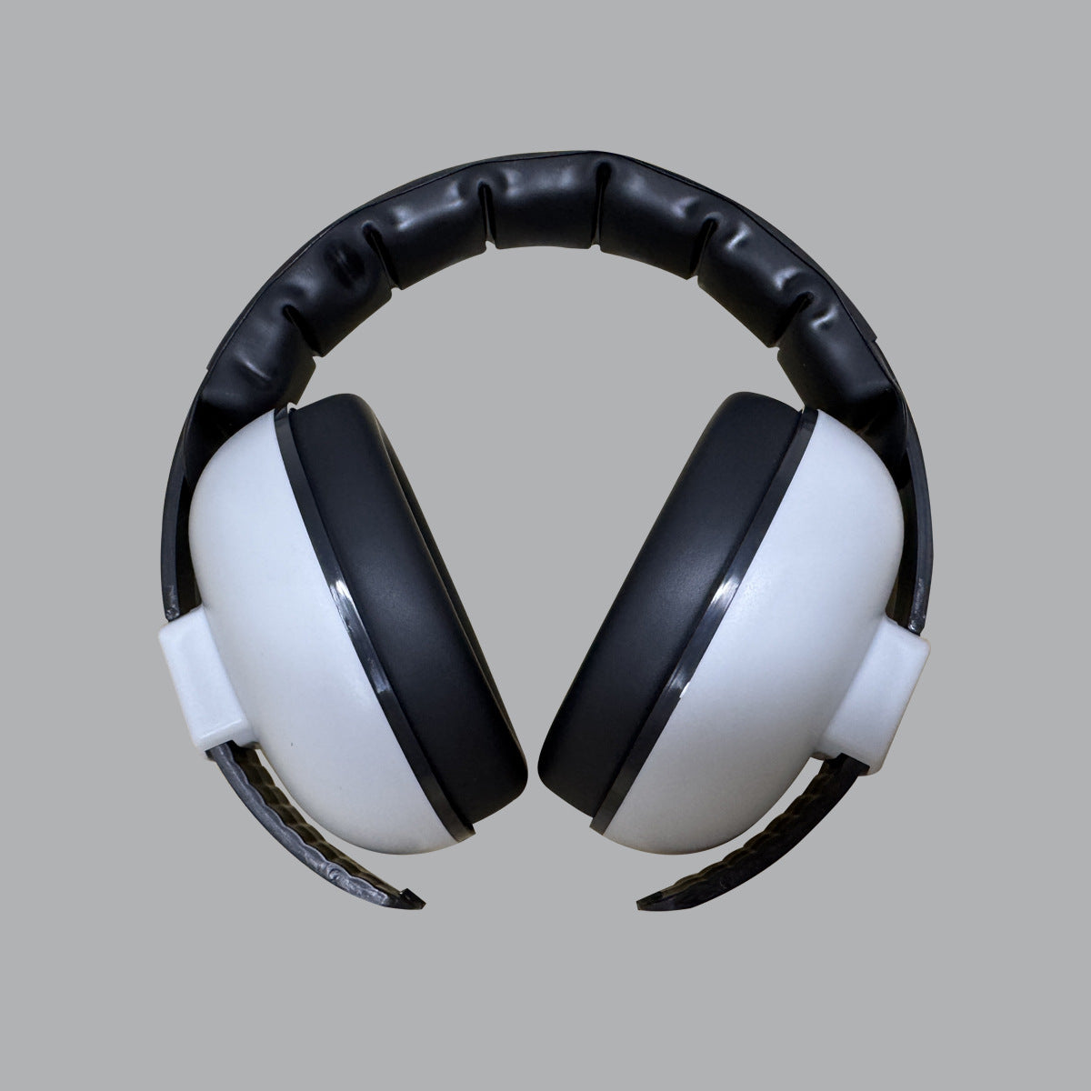Pair of black and white headphones on a gray background