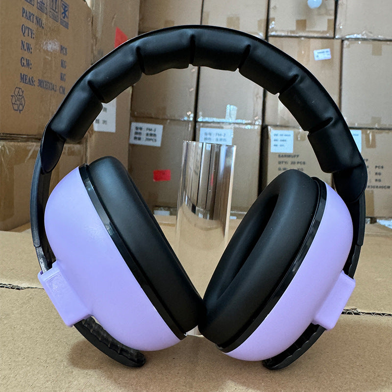 Black and purple headphones on a cardboard box background